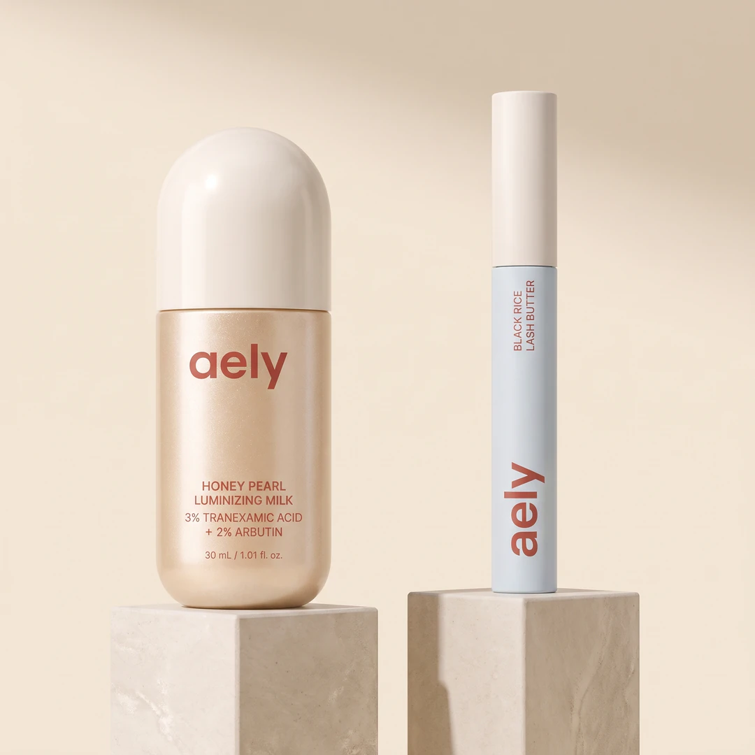 The Lit and Lifted Duo: the Honey Pearl Luminizing Milk beside the Black Rice Lash Butter, both named on the packaging